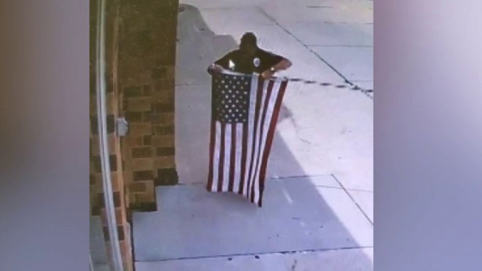 Nebraska officer seen fixing fallen US flag at auto-repair shop: 'The respect it deserves'