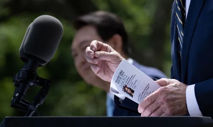 President Biden Holds Note With Reporter’s Question Before Calling on Her