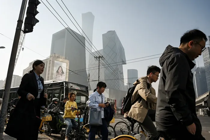 Beijing Afraid Iran Strikes Will Spur Uprising in China, Insiders Say | USNN World News People cross a road on their way to work in Beijing’s central business district on April 10, 2025. Greg Baker/AFP via Getty Images